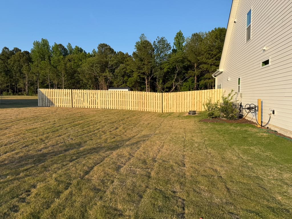 Black aluminum ornamental fence along a backyard