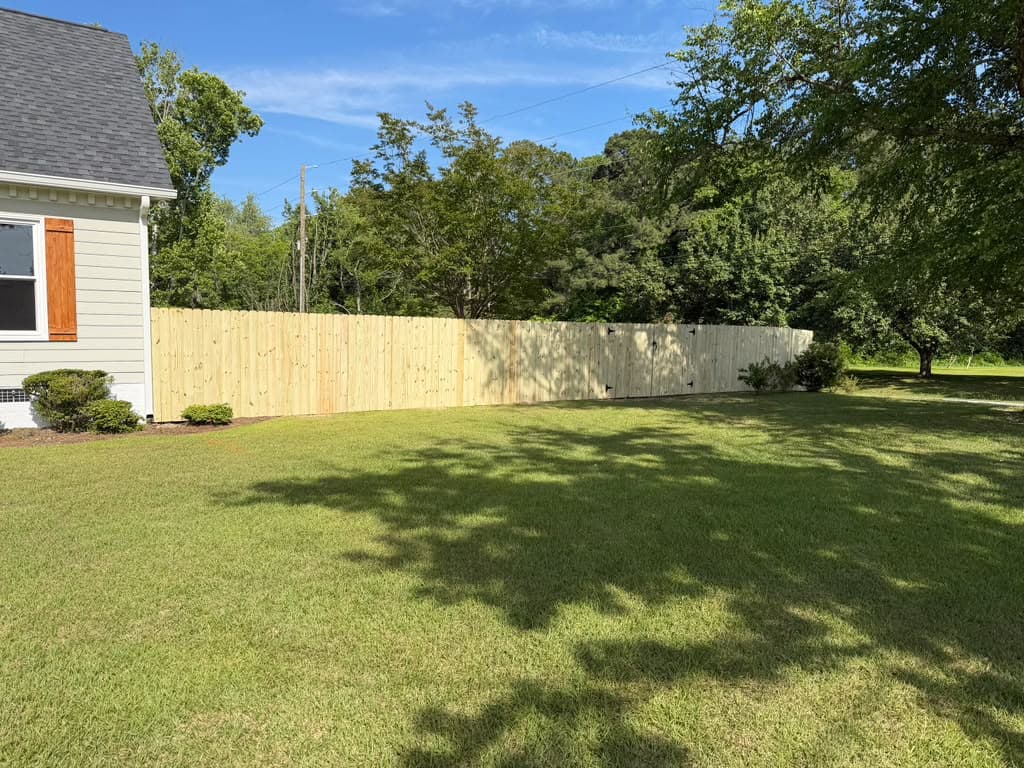 Ornamental aluminum fence enclosing a garden area